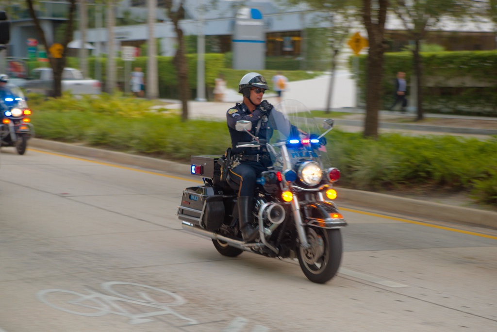 This motorcycle policeman was leading the bus with The Heat to the stadium before they won the NBA