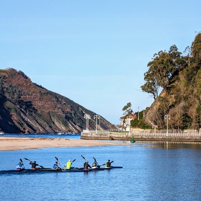 A group of kayakers paddling on a calm river