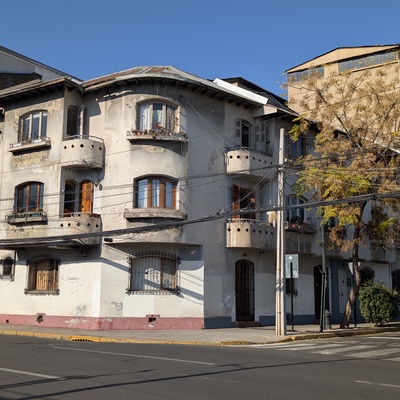 An old, multi-story building on a street corner.